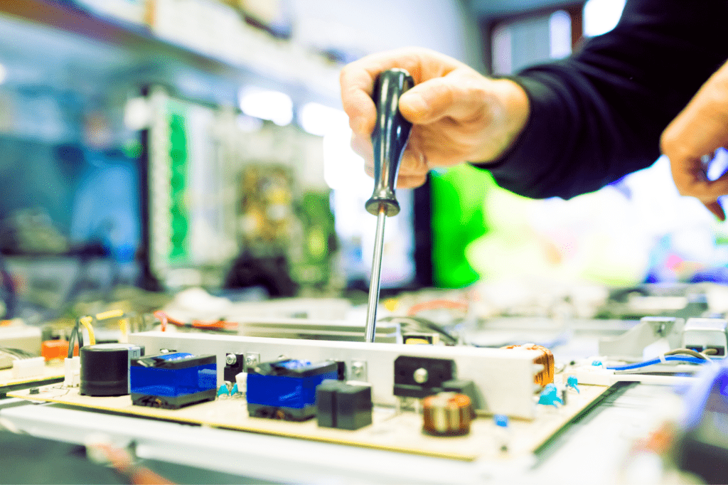 TV repair man working on big plasma television